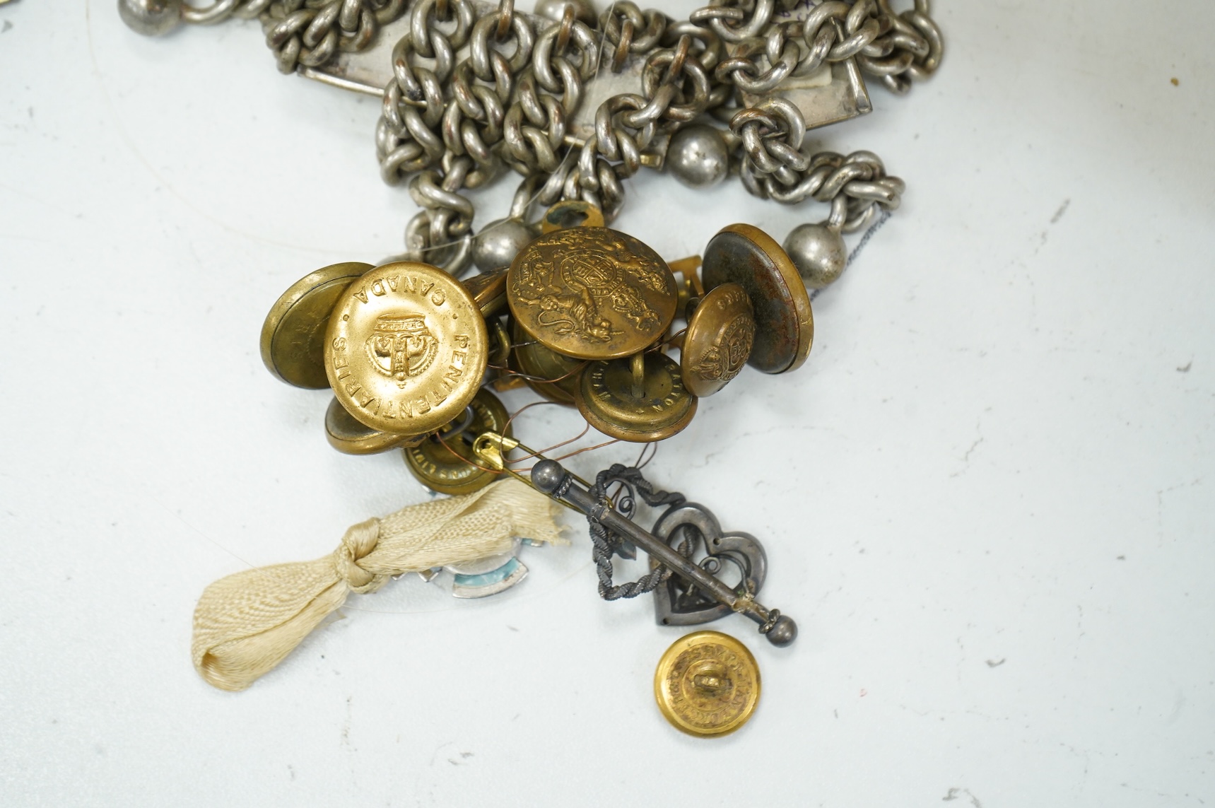 A collection of militaria, etc. including; a Gordon Highlander’s kilt and sporran, three early 20th century Union Flags, a Victorian beaded ‘sweetheart’s’ cushion, two empty First World War Princess Mary Christmas tins,